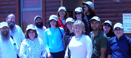 A dozen members of the Chabad Center of Metairie stand outside a building in Nitzan, Israel.